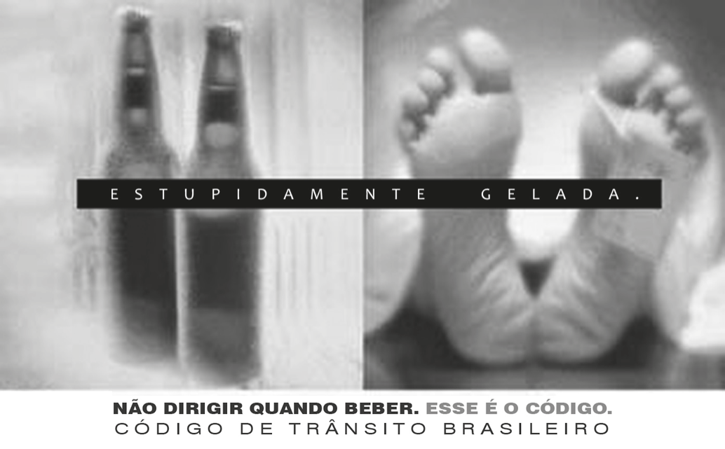 Peça publicitária em preto e branco dividida em duas imagens: à esquerda, duas garrafas de cerveja cobertas de gotas de água gelada; à direita, os pés de um corpo deitado, cobertos por um lençol, com uma etiqueta de identificação presa ao dedo, como num necrotério. Sobre as duas imagens, uma faixa preta com a frase “ESTUPIDAMENTE GELADA.”. Abaixo: “NÃO DIRIGIR QUANDO BEBER. ESSE É O CÓDIGO.” e “CÓDIGO DE TRÂNSITO BRASILEIRO”.
