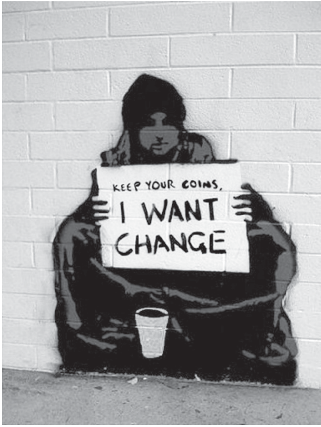 Grafite em estêncil sobre um muro de tijolos: uma pessoa encapuzada, sentada no chão, segura um cartaz escrito à mão 'KEEP YOUR COINS, I WANT CHANGE'; à sua frente, um copo descartável para esmolas.