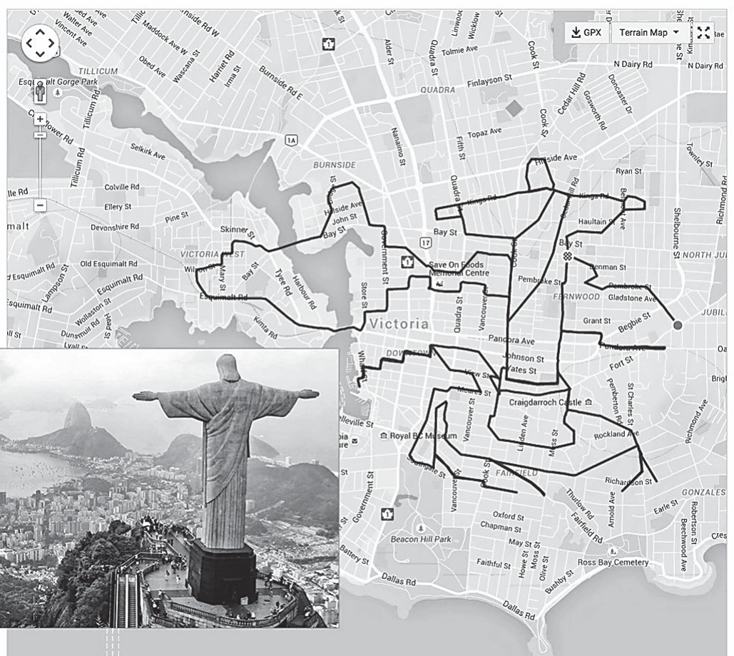 Captura de tela de um mapa digital da cidade de Victoria, no Canadá, em tons escuros, com nomes de ruas e os controles do aplicativo (botões de zoom, 'GPX', 'Terrain Map'). Sobre as ruas, um trajeto em traço branco grosso desenha a silhueta do Cristo Redentor de braços abertos, com o pedestal na parte inferior. No canto inferior esquerdo, inserida sobre o mapa, uma fotografia em preto e branco da estátua do Cristo Redentor no Rio de Janeiro, vista de costas, com a baía ao fundo.