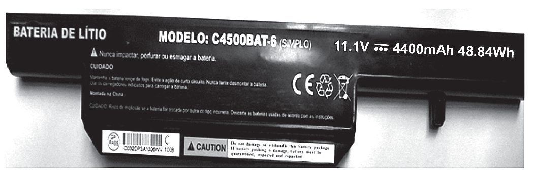 Fotografia em preto e branco de uma bateria de notebook, vista por cima, com o rótulo impresso: "BATERIA DE LÍTIO", "MODELO: C4500BAT-6 (SIMPLO)", "11.1V ⎓ 4400mAh 48.84Wh", avisos de cuidado em letras pequenas, símbolos de certificação e reciclagem, um código de barras e uma etiqueta "CAUTION".